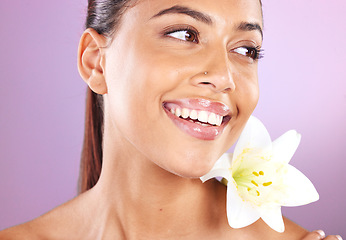 Image showing Beauty, wellness and woman with a lily flower in studio for a health, cosmetic and natural face routine. Skincare, health and healthy girl model from Brazil with floral isolated by purple background.