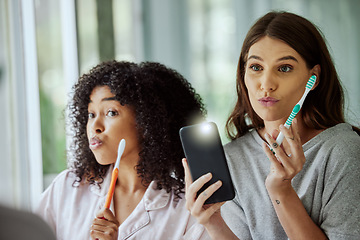 Image showing Phone selfie, face and friends brushing teeth, goofy routine and morning social media update in a bathroom. Crazy, flash photo and women with toothbrush for dental care and mobile for picture