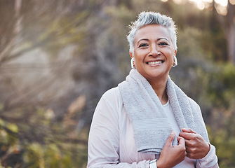 Image showing Exercise, music and portrait of a senior woman outdoor with earphones and towel for fitness in nature. Elderly female in woods to run for healthy lifestyle, body and energy with cardio workout