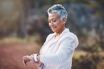 Image showing Smartwatch, exercise and senior woman on nature trail for running, cardio and a fitness app workout. Elderly female with a watch in a forest to run for healthy lifestyle, body and energy with cardio