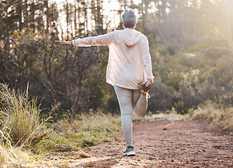 Image showing Fitness, forest or senior woman stretching in nature to start training, exercise or hiking workout in New Zealand. Back view, balance or healthy elderly person with focus, body goals or motivation