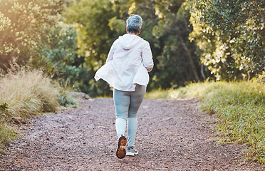 Image showing Fitness, back and senior woman running in nature, park or outdoors alone. Sports, marathon and retired elderly female training, exercise jog or cardio workout for cardiovascular health and wellness.