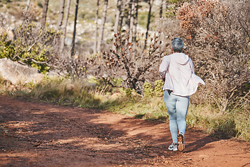 Image showing Fitness, runner or old woman running in nature training, exercise or cardio workout in New Zealand. Back view, wellness or healthy senior person exercising with resilience, body goals or motivation