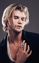 Image showing Beauty, fashion and accessories with a man model in studio on a gray background for transsexual equality. Gender neutral, non binary and style with a handsome young male posing in designer clothes