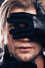 Image showing Fashion, leather gloves and portrait of a model in a studio with edgy, punk and trendy style. Non binary, LGBTQ and closeup of a man with a luxury, fantasy or stylish creative dark aesthetic.