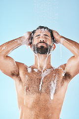 Image showing Soap, water or man in shower cleaning skin, washing face or body in healthy morning grooming routine in studio. Blue background, relaxing or male model with self care, self love or foam for hair care