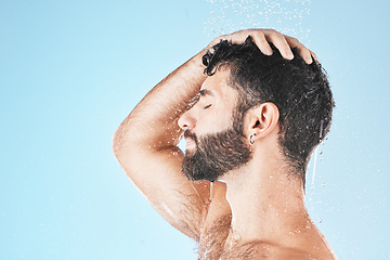 Image showing Hair care shower, face and water splash of man in studio isolated on a blue background mockup. Water drops, skincare or profile of male model washing, cleaning or bathing for healthy skin and hygiene