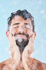 Image showing Wellness, water or man in shower cleaning skin or washing face and body in morning grooming routine in studio. Blue background, hands or healthy male model with self care, self love or a happy smile