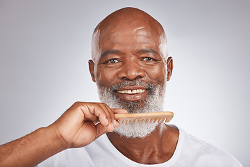 Image showing Elderly, black man with comb for beard, beauty and grooming with hygiene and cosmetic care against studio background. Hair care mockup, brush body hair and face portrait with treatment and cosmetics