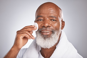 Image showing Portrait, cosmetics and black man with facial cotton, skincare and dermatology on grey studio background. African American guy, senior male and makeup pads for face detox, beauty and luxury self care