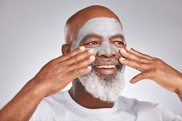 Image showing Senior, hands or black man with facial cream marketing or advertising a luxury beauty product for self care. Studio background, cosmetics or African old man with a happy smile applying facial mask