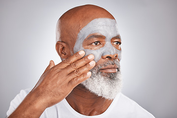 Image showing Skincare, hand or old man with facial cream marketing or advertising a luxury beauty product for self care. Studio background, cosmetics or senior black man applying face mask for clean glowing skin