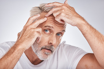 Image showing Skincare, health and man pop a pimple before a cosmetic, beauty or self care treatment in a studio. Wellness, cosmetics and senior guy doing a face routine for a blemish isolated by a gray background