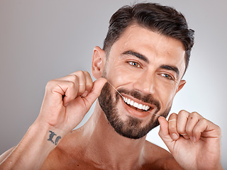 Image showing Floss, teeth whitening and happy man with healthy dental lifestyle, wellness or skincare on studio background. Male model face, tooth flossing and cleaning mouth of facial smile, fresh breath or body