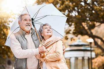Image showing Senior couple, umbrella and walking outdoor for relax freedom, calm quality time and relationship bonding in summer. Elderly man, woman and wellness walk in countryside park together for love or care