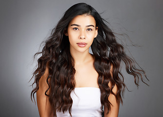 Image showing Hair, hair care and woman, face and beauty, glow and shine with keratin treatment. Cosmetic mockup, waves and texture with hair style with studio background. Wellness, self care portrait and growth.