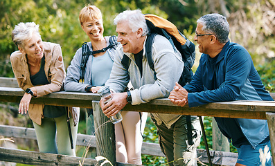 Image showing Elderly, people hiking and happy in park with fitness outdoor, relax on bridge while trekking in nature together. Health, wellness and hiker group, sport and active lifestyle motivation with cardio.