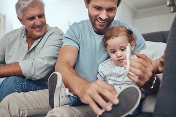 Image showing Family, love and dad with child on sofa to tie shoes laces enjoying weekend, quality time and bonding together. Family home, support and grandfather, father and boy relaxing on couch in living room