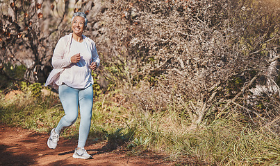 Image showing Fitness, happy and senior woman running in nature for cardio, morning motivation and marathon training in Australia. Freedom, wellness and elderly runner with a smile for outdoor exercise in a park