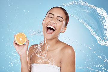 Image showing Water splash, beauty and woman, clean with orange for organic cosmetic care and hygiene in shower. Water, fruit and vegan skincare treatment with splash and excited female against studio background