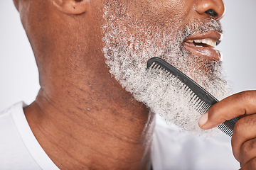 Image showing Elderly, black man with comb for beard, beauty and grooming closeup with face hygiene and cosmetic care profile. Hair care, brush body hair and treatment with cosmetics against studio background