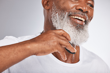 Image showing Beard, beauty and shaving with a senior black man cutting his facial hair in studio on a gray background for grooming. Happy, skin and face with a mature male using scissors to cut for a shave