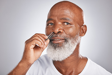 Image showing Senior man, nose hair and tweezer for self care, hair removal and epilation for beauty and grooming . Headshot of black male with beard on grey studio background for body care, hygiene and clean skin