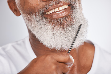 Image showing Elderly, black man with comb for beard, beauty and grooming zoom with face hygiene and cosmetic care. Facial hair closeup, brush body hair and treatment with cosmetics against studio background