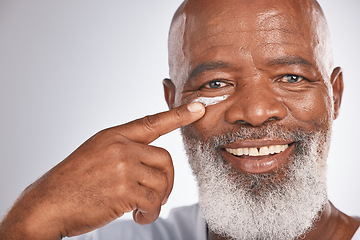 Image showing Black man, beauty and face cream for skincare of senior in studio for self care with dermatology and cosmetic product. Portrait of happy male with lotion on skin for glow, health and wellness on grey