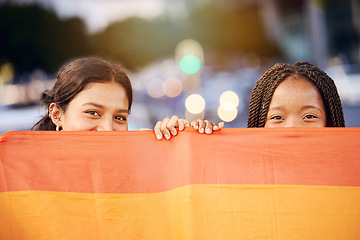 Image showing Love, pride flag and portrait of a lesbian couple at a LGBTQ, freedom or community parade in the city. Happy, celebration and interracial gay women with commitment at a LGBT, rainbow sexuality event.