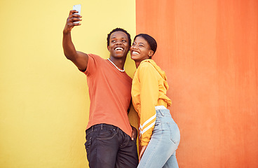 Image showing Selfie, black couple and smile with gen z youth, smartphone and influencer with post for social media against color wall background. Happy in picture, fashion mockup and tech with young man and woman