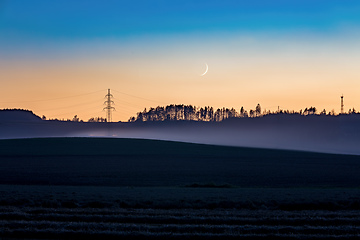 Image showing countryside landscape after sunset with moon