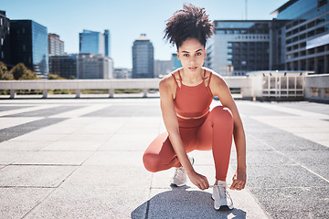 Image showing Fitness, portrait and black woman tie shoes getting ready for training in city. Face, sports and female runner tying sneaker lace and preparing for workout jog, running or exercise outdoors on street