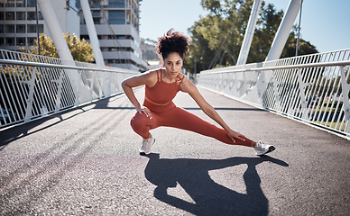 Image showing Stretching legs, fitness portrait and woman on city bridge exercise, runner and training in sports shoes fashion. Warm up, focus and urban athlete on ground workout for body, muscle and health goals