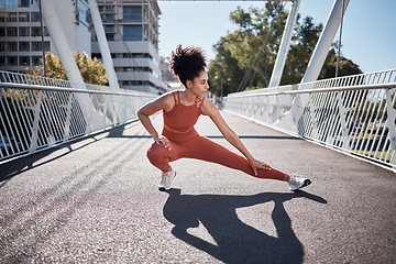 Image showing Sports, stretching legs and woman on ground or city bridge exercise, running and training in sports shoes fashion. Warm up, focus and athlete or black woman workout for body, muscle and health goals