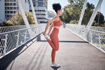 Image showing City, stretching legs and body of woman in fitness exercise, runner workout or training in sports fashion on bridge. Warm up, focus and urban athlete in pilates motivation for muscle and health goals