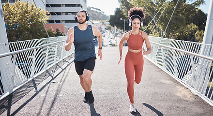 Image showing Fitness, couple and running with headphones for city exercise, workout or marathon training. Young man, woman and outdoor cardio sports with music, motivation and focus for wellness, energy or action