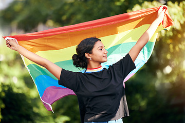 Image showing Rainbow, flag and human rights with an indian woman in celebration of lgbt gay pride alone outdoor. Freedom, equality and lgbtq with a happy female outside celebrating her equality or inclusion