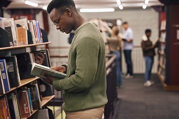 Image showing Black man student, reading and library with book, research and education at college to ready for exam. African gen z man, books and shelf at university for study, learning and motivation in Boston