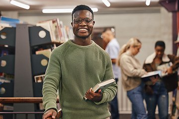 Image showing Black man, book and portrait in library with smile, research and studying at college for education. African gen z student, happy and university for books, learning or vision for future career goal