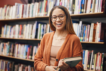 Image showing Face, student and woman in university in library ready for learning. Portrait, education and happy female from Brazil standing by bookshelf with book for studying, knowledge and literature research.