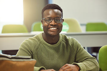 Image showing Black man, student and portrait in classroom for education, study and happy at college with smile. African gen z learner, class and desk at university for goals, learning and motivation for future