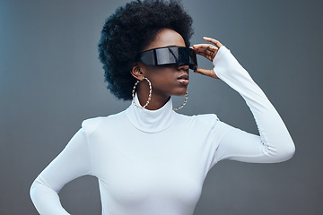 Image showing Futuristic sunglasses, fashion and black woman, young gen z and stylish with trendy designer brand against studio background. Model, cyberpunk and natural curly hair with beauty and edgy style