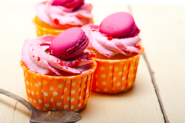 Image showing pink berry cream cupcake with macaroon on top