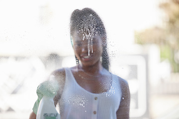 Image showing House work, window cleaning and black woman with bottle to spray soap while spring cleaning windows with gloves. Housework, dirt and woman happy working to clean dust on glass in New York apartment.