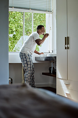 Image showing Oral care, brushing teeth and black man with dental hygiene in the bathroom of his modern home. Grooming, healthcare and young African guy cleaning his mouth for a health and wellness morning routine