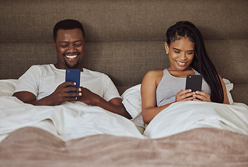 Image showing Black couple, smartphone and happiness together in bed for social media streaming, relax quality time or reading online. African man smile, black woman and happy watching video on phone in bedroom