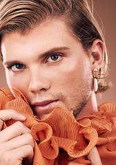 Image showing Lgbtq, fashion and portrait of man with makeup, beauty and creative orange clothes on studio background. Transgender, face and queer model with skincare cosmetics, gay pride and non binary identity