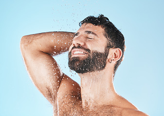 Image showing Shampoo, shower and cleaning with a model man washing his hair in studio on a blue background for natural care. Keratin, treatment and water with a male wet in the bathroom while grooming alone