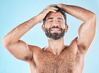 Image showing Cleaning, hair and keratin treatment with a man model using shampoo in studio on a blue background for hygiene. Water, hydration and natural with a handsome male washing in the shower for haircare